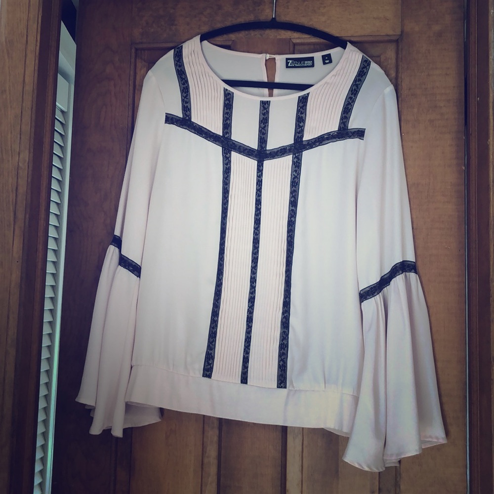 Pink peasant top with bell sleeves.